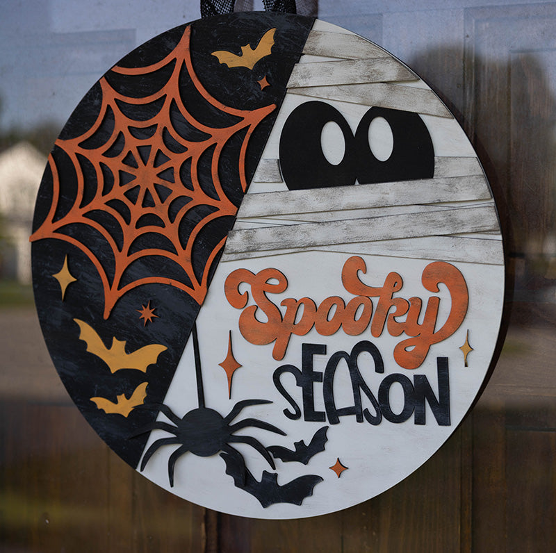 Halloween-themed decorative door hanger with spider web, spider, bats, and 'Spooky Season' text from Thistlewood Creations.
